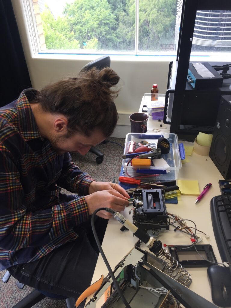 Sam King repairing playback equipment in the Melbourne PARADISEC lab